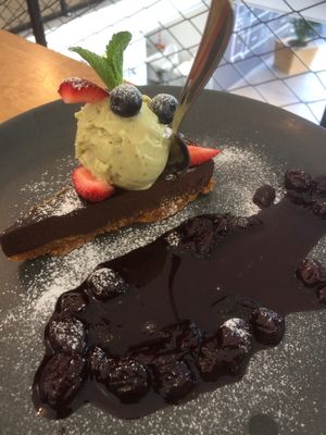 Chocolate cake with ice cream and cherry compot at Trickster Tihane in Tartu