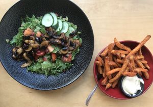 Vegan mushroom and pesto salad and delicious sweet potato fries with vegan mayonnaise. at Trickster Tihane in Tartu