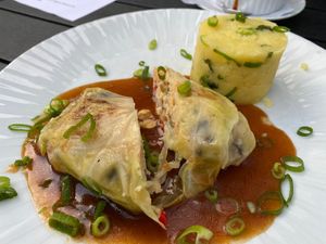 Vegan Kohlroulade filled with mushroom, paprika, chickpeas, and couscous in a red wine sauce. Served with mashed potato. at Hotel Gasthof Schaeffler in Sonthofen