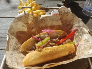 Apple sausage with mushrooms, peppers, pickled onions, apple horseradish, and fries. at King's BierHaus in Houston