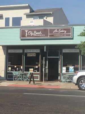 Store front with clearly labeled vegan options advertised at City Beach Organics in Sandpoint