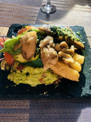 Huge super filling and delightful dish with rice, beans, peppers, mushrooms, tomatoes, chickpeas omelette, guacamole and other greens. Beautiful 😋  at Andino Gastrobar in Malaga