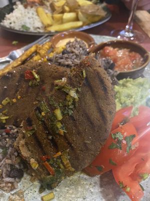 Lentil burger with an array of delicious accompaniments  #Veganuary at Andino Gastrobar in Malaga