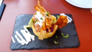 Tortino di patate con jackfruit, platano fritto, salse e avocado at Andino Gastrobar in Malaga