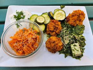 Rice-bulgur balls, spinach-tofu stir-fry, oven-baked zucchini, herb dip, carrot salad at Dreizehn in der Muehle in Augsburg