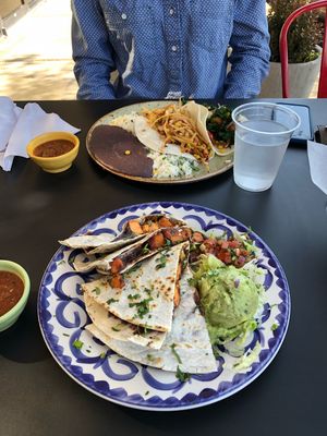 Sweet potato and black bean vegan quesadilla.  Food across the table is Ranchero taco. at Taco Ocho in Frisco