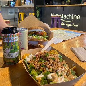 Loaded fries, smash burger, local craft beer, and oat milk latte. at Veg Machine in Tallinn