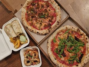 The pizzas are not from VegMachine. Loved the lovely Caesar wrap with best fries ever and the onion rings! at Veg Machine in Tallinn