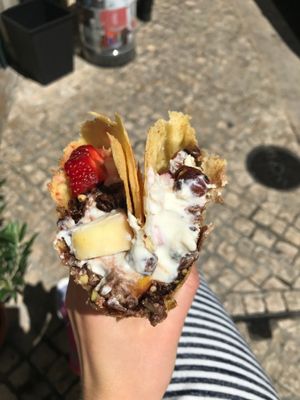 The goods in the Lindsay: fruit (apples, strawberries), vegan yogurt (tasted like a plain, unsweetened soy yogurt), chocolate granola with hazelnuts, sunflower seeds, and oats, and a drizzle of agave; served in a vegan, GF crepe.  INCREDIBLE COMBINATION!!!  at Sama Sama Catering in Lisbon