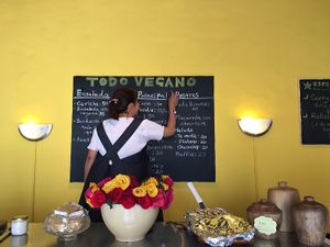 Flora writing today's menu at Loving Hut - San Cristobal in San Cristobal De Las Casas