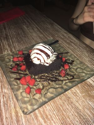 Amazing Vegan Brownie with coconut ice cream, chocolate sauce and strawberries! at Clear Cafe in Ubud