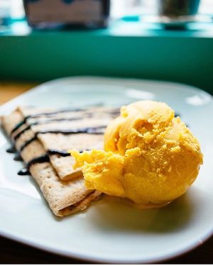 Vegan combo of gluten free flaxseed crepe and flavourful mango gelato. at Joylato in Reykjavik