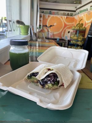 Chickpea wrap with avocado and part of the interior in background  at Mason Bar in New Smyrna Beach