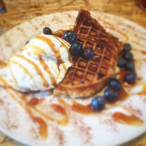 Waffles with blueberries and caramel, and ice cream  at Grumpy Panda Slice Shop & Deli in Gateshead