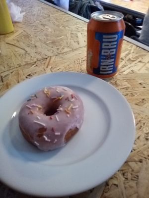 Strawberry  frosted doughnut with Irn Bru at Grumpy Panda Slice Shop & Deli in Gateshead