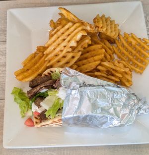 Gyro with seasoned waffle fries at Simply Green Cafe in Ramsey