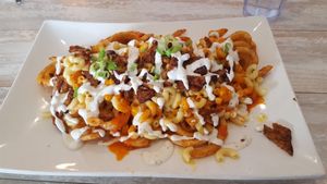 Loaded fries special. Curly fries, mac & cheese, bacon bits, ranch, buffalo, scallions. at Simply Green Cafe in Ramsey