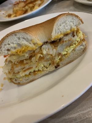 Scrambled tofu with hash browns and cheese on a toasted bagel at Simply Green Cafe in Ramsey