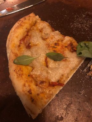 Pizza but I ate most of it before photo because it’s too delicious, pizza tomato and cashew sauce  at Sarinbuana Eco Lodge Restaurant in Tabanan