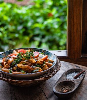 Pasta penne with a light tomato and freshly picked herb sauce.  at Sarinbuana Eco Lodge Restaurant in Tabanan
