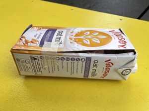 Raspberry lemon curd cake in an oat milk container box   at Let Them Eat Vegan in Dunedin