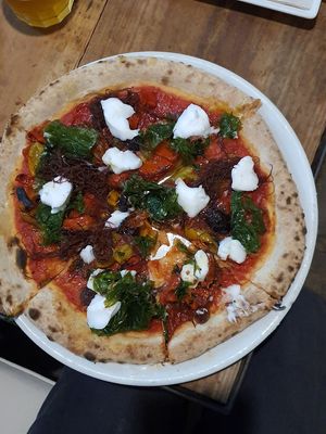 Pizza with vegan cheese at Tarifa EcoCenter in Tarifa