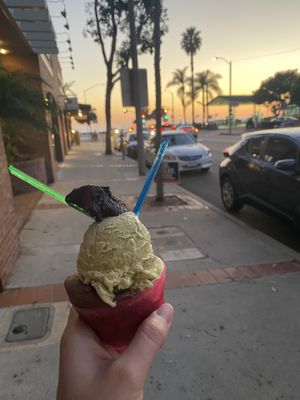 Pistacio and chocolate with a seasonal fudgey flavor on top  at Dolce Gelato in Laguna Beach