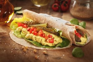 Hummus Wrap - home made hummus with lots of spices, with pickles, tomatoes, lettuce and a sourdough flat bread
 at Sara Green - Vegan Bistro in Bucharest