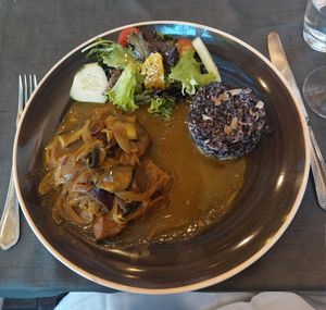 Photo doesn't do the taste any justice. Seitan wild mushrooms and risotto. The side salad was also delectable. at Lusitania in Alvor