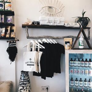 Protein shakes, coconut nectar, tote bags and t-shirts, kombucha all for sale.  at Cafe Organic in Canggu