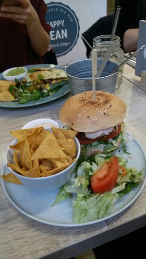 "Meat" burger with vegan cheese and nachos at Happy Bean in Prague