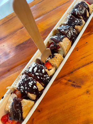 VEGAN ROLLED PANCAKE - with strawberries, bananas, chocolate sauce and powdered sugar. at The Happy Pig Pancake Shop in Amsterdam