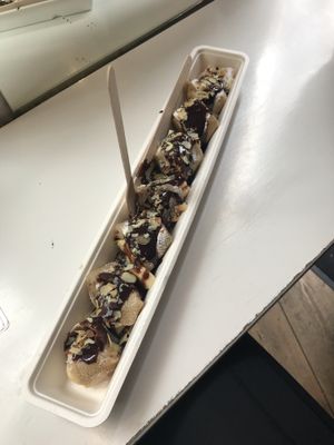 Vegan pancakes with icing sugar, chocolate sauce, banana and almonds at The Happy Pig Pancake Shop in Amsterdam