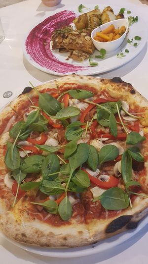 "Tenderloin" and salami pizza with fresh spinach leafs at Vegan Port Pizza & Restaurant in Gdansk