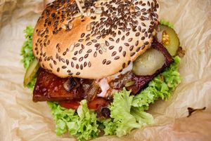 Burger with tofu marinated in BBQ sauce, lettuce, pickled cucumber, onion at Vegan Port Pizza & Restaurant in Gdansk