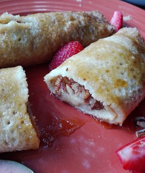 Pancakes with a banana, nut filling and strawberries. at The Secret Garden in Benoni