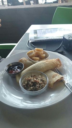 Pancakes with walnuts, maple syrup, and bananas at The Secret Garden in Benoni