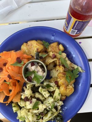 Crushed baked potatoes with cauliflower salad and pickled carrots  at Cafe Nyfiket in Raettvik