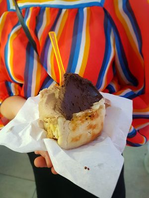 Three scoops of vegan ice cream in a brioche bun at Al Gelatone in Palermo