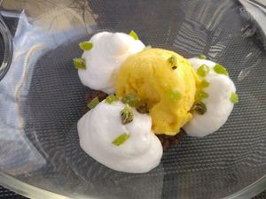 Mango ice cream with coconut foam, carob crumble and kiwi topping at Noname Restaurant in Mallorca