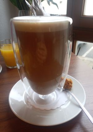 Chai Latte with plant based milk made of peas, little vegan granola treat at Zoom Cafe in Chemnitz
