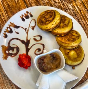 Pankakes de Quinoa con compota de manzana y pasas  at Zula Vegetarian Paradise in Seminyak