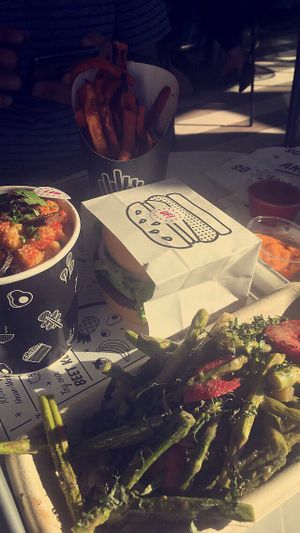 Classic burger on a gluten free bun and seasonal vegetable side. at By Chloe - Fenway in Boston