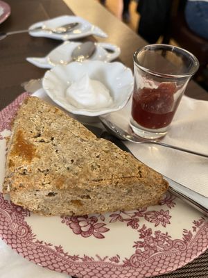 Gluten free scone with coconut cream and jam. A standout!   at The Tea Lounge in London