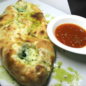 Calzone relleno de espinacas, queso vegan y pasas.  at Masa Madre in Madrid