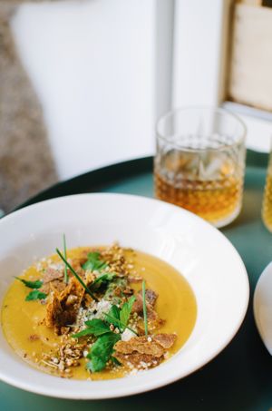 Sweet potato cream soup with homemade raw seed crackers and fresh herbs - Our soups change daily at Bunny's Deli in Madrid
