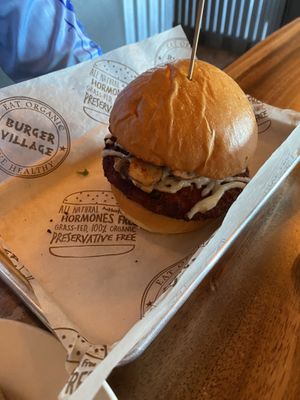 Veggie burger with the spicy vegan topping   at Burger Village in Hicksville