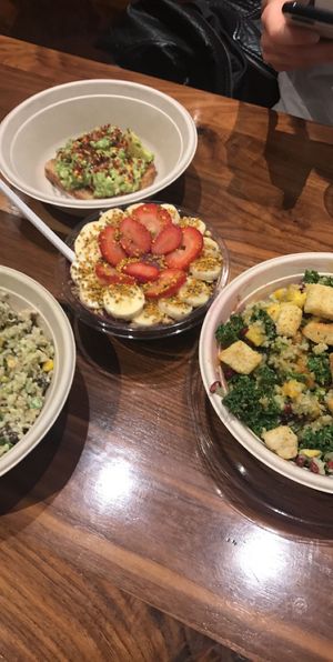 smoothie bowl in center, salad, and avocado toast at Upbeet in Atlanta