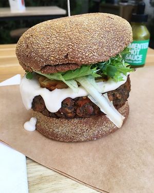 Tropical Burguer feito com Pão Australiano e Hamburguer de Lentilha, Cogumelos Paris e Nutricional Yeast. Ketchup e maionese caseiros da urban, abacaxi assado, picles, mozarela de castanhas alface e microgreens!!!!!  at Urban Farmcy in Porto Alegre