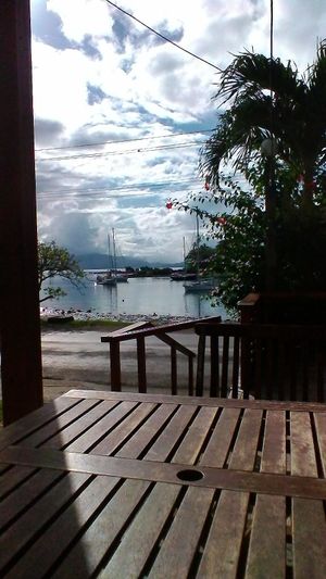 Beautiful view from the tables out front. Boats in the harbor and Nawi Island.  at Grace Road Kitchen in Savusavu